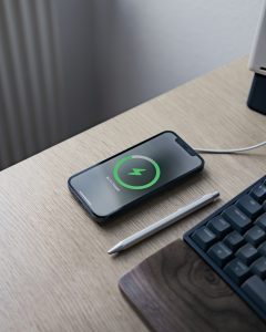 A picture of a phone being charges- on it's screen is a green circle with a lightning bolt in the middle. The circle is filled up 75% of the way.