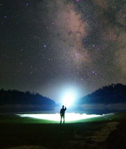 Someone holding a LEP Flashlight with the setting on a high brightness level.