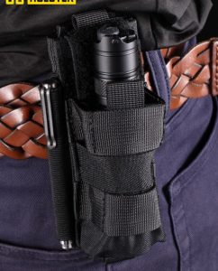 A picture of someone with a flashlight holster on their pants.