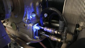 Oil that is leaking from a machine glows under a UV light.