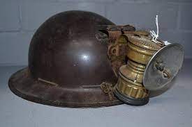 A carbide lamp on top of a miners hat. This was one of the first headlamps that was created.